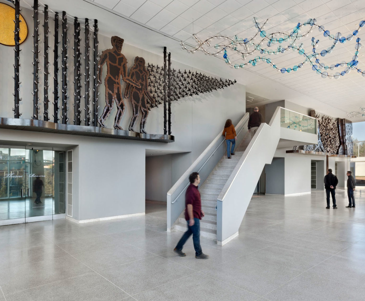 Visitors ascend the staircase below a Richard Jolley installation at the Knoxville Museum of Art.