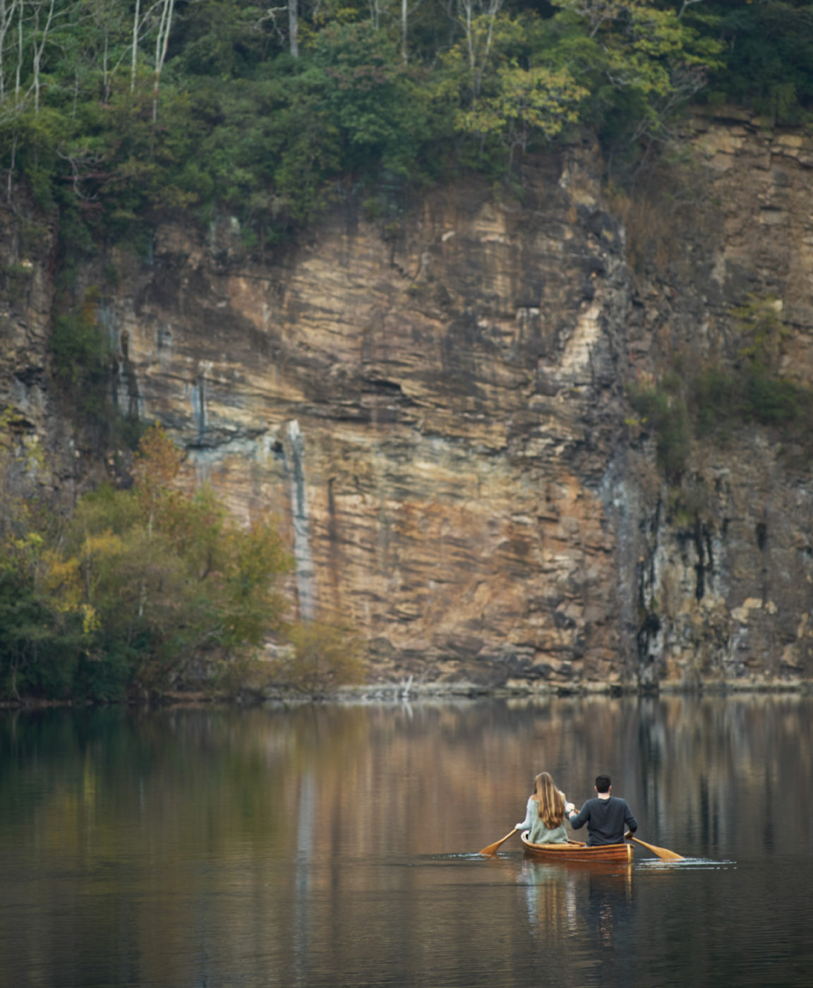 A couple paddles a canoe in the quarry lake.