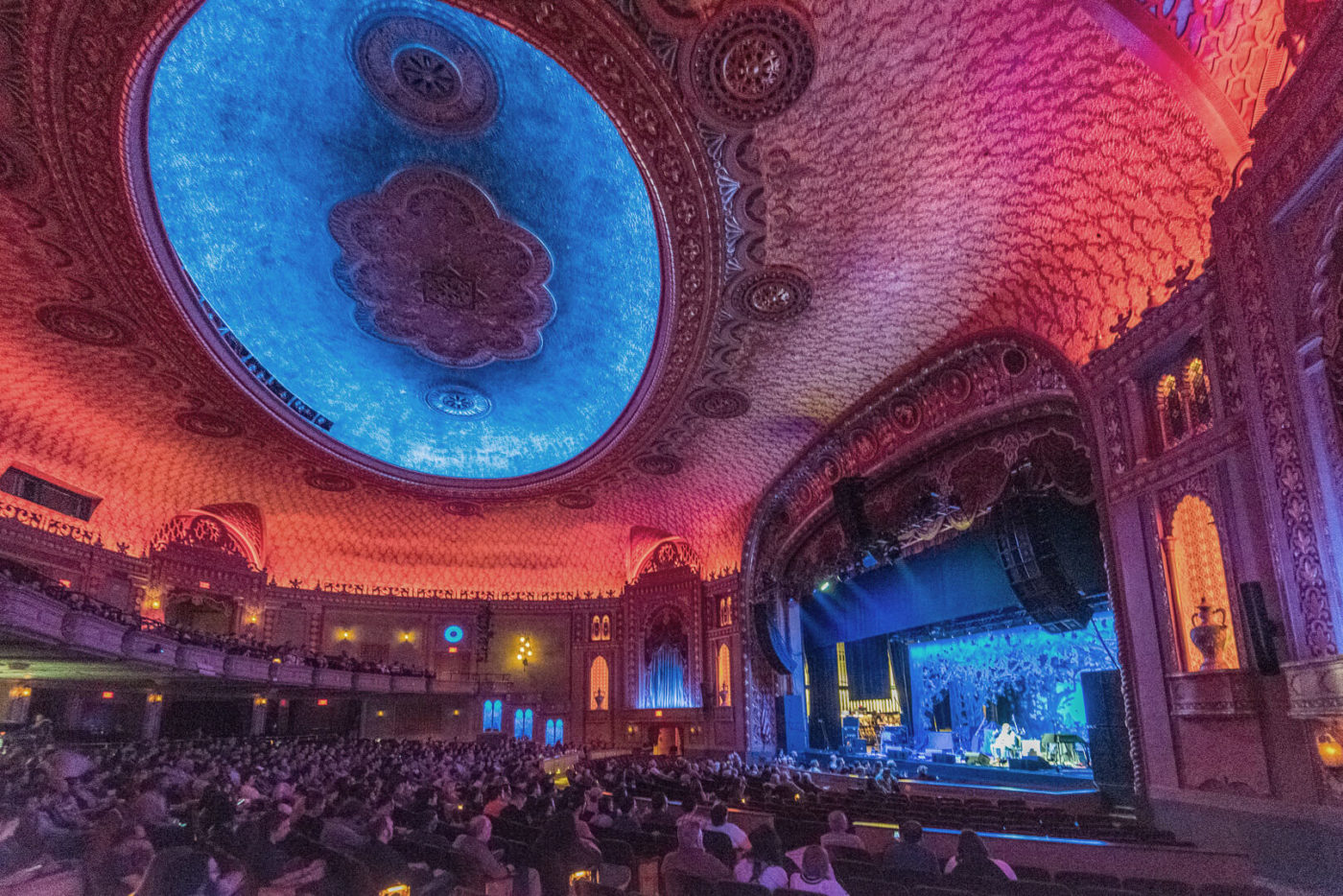 A photo of the ceiling illuminated in blue and red inside the Tennessee Theatre's concert hall.