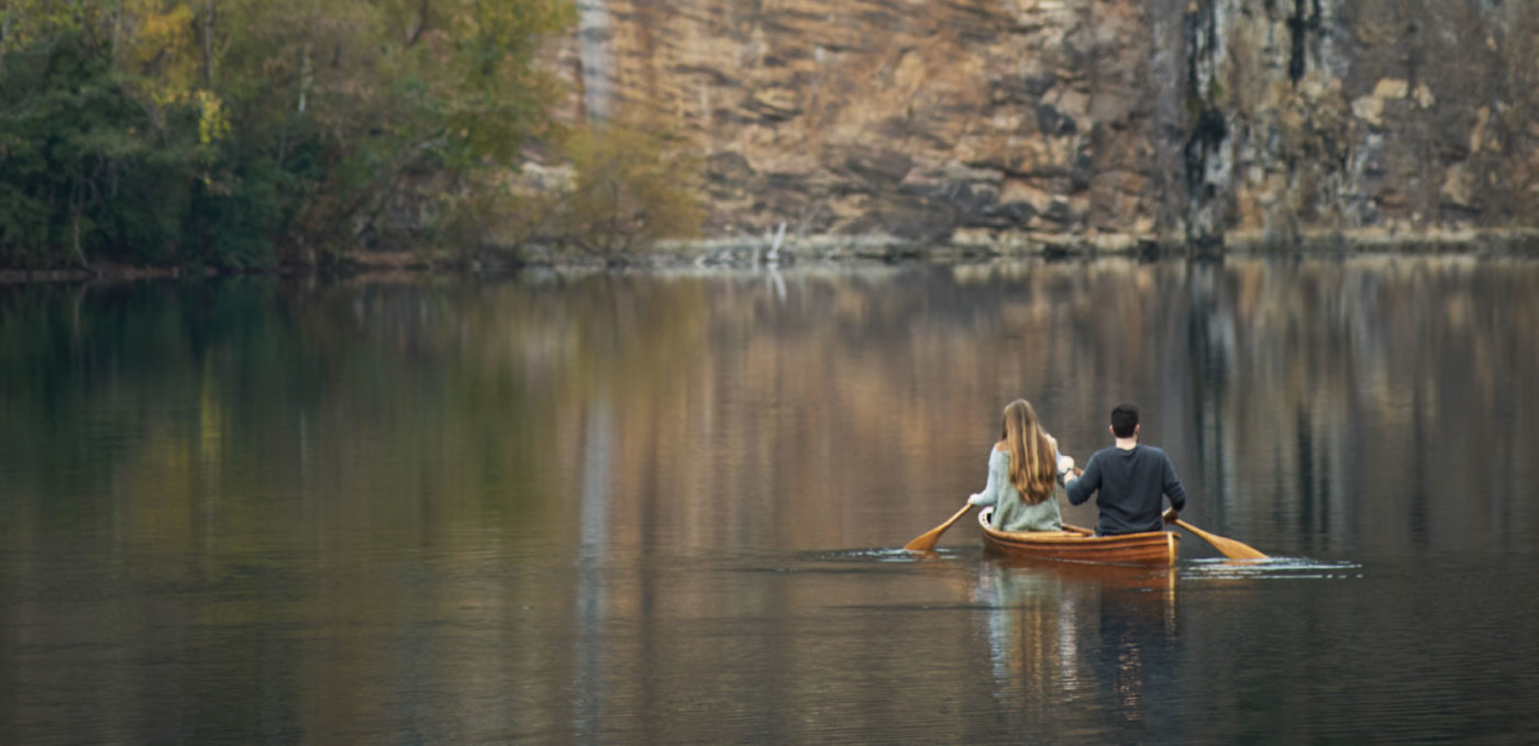 A couple paddles a canoe in the quarry lake.