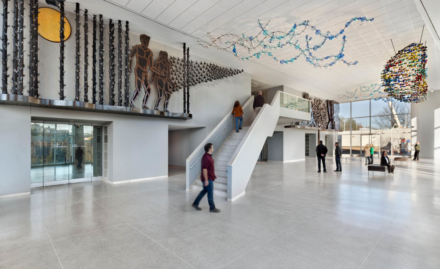 Visitors ascend the staircase below a Richard Jolley installation at the Knoxville Museum of Art.