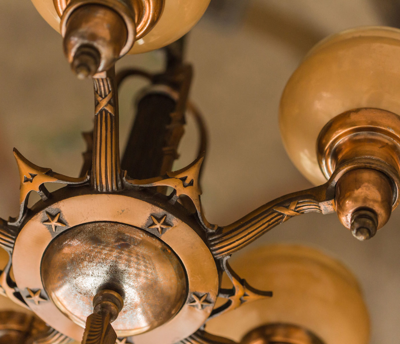 A detail photo of an ornate light fixture inside the building.