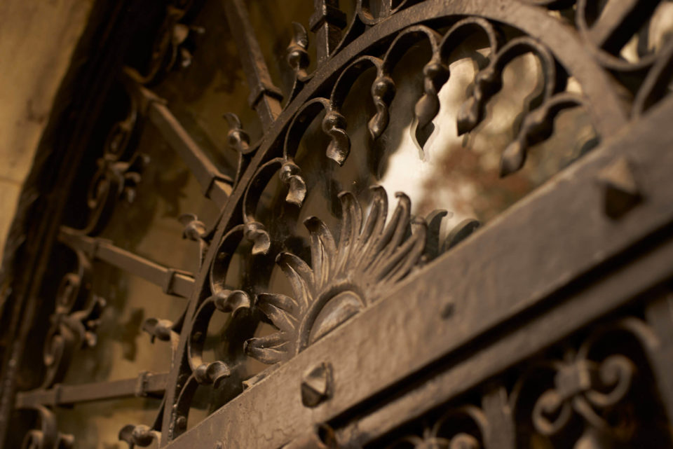 A detail photo of the ornate ironwork covering the front entrance.