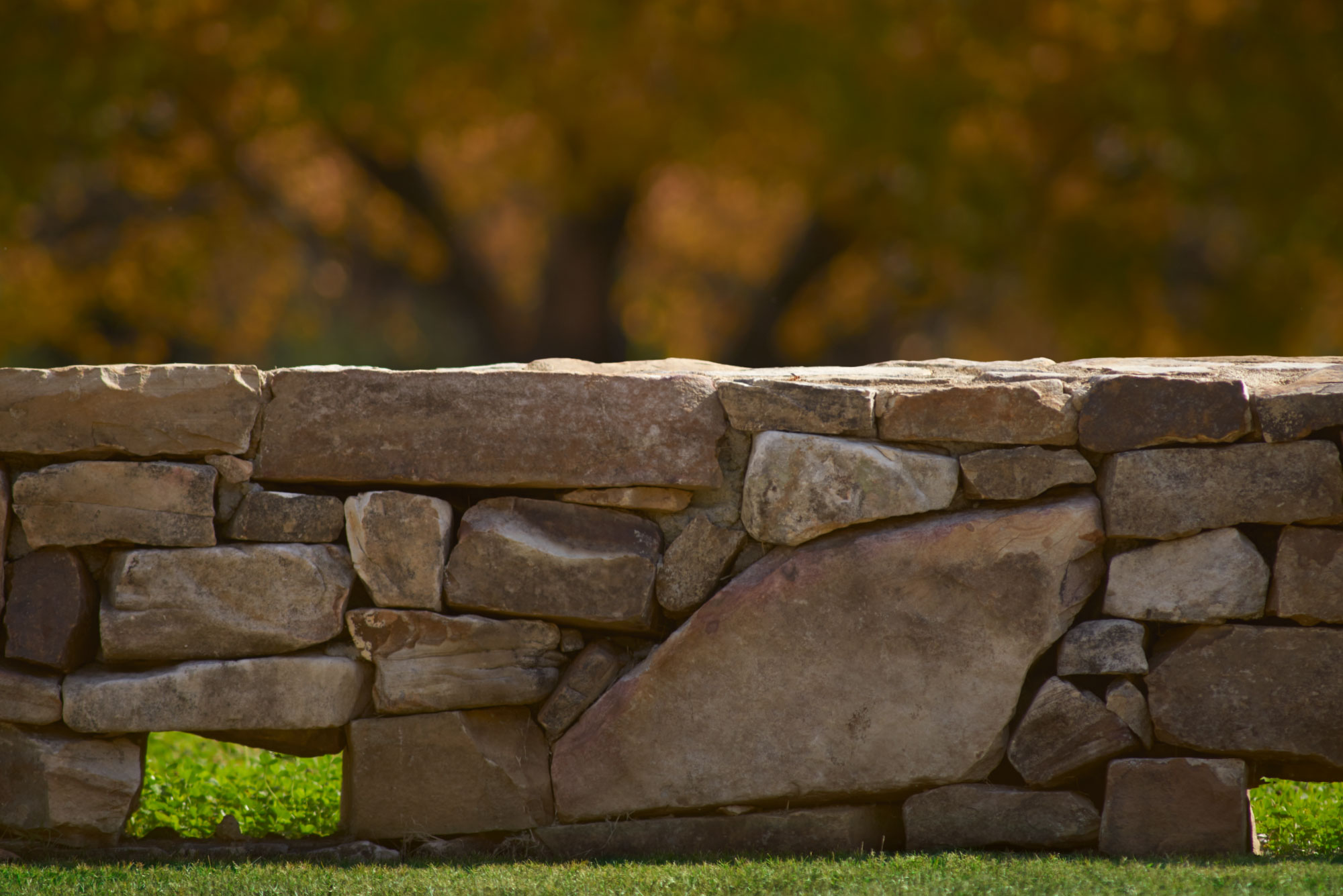 Photo of a stacked stone wall.