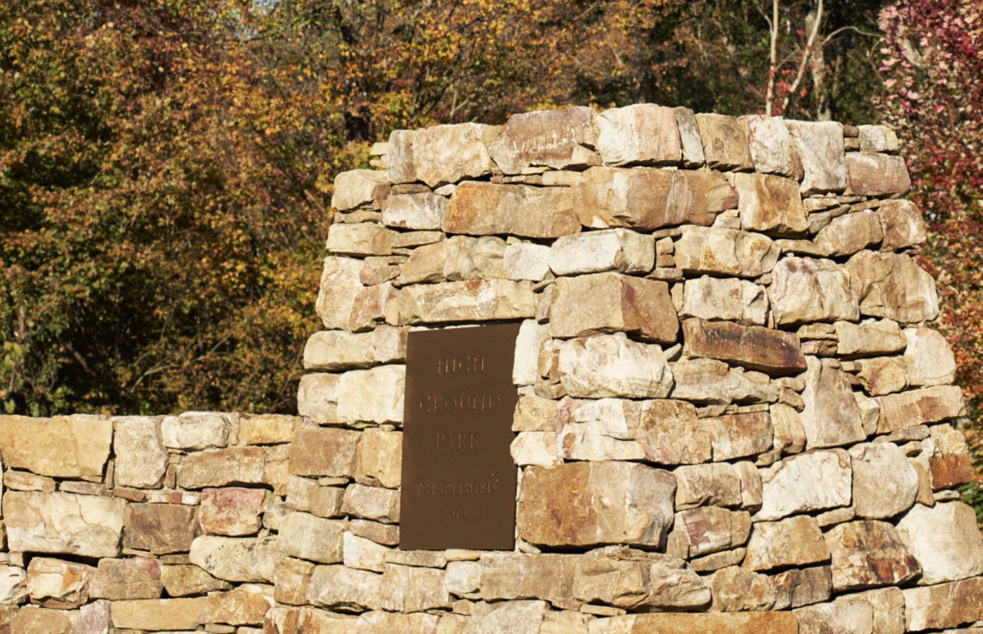 A stone fortification overlooks the woods.