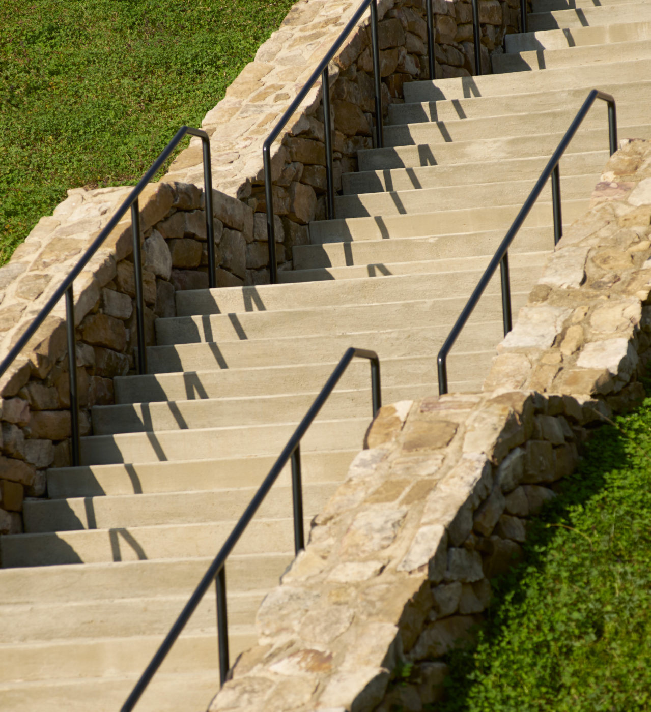 Stone and concrete steps lead up a steep hill at the entrance of the park.