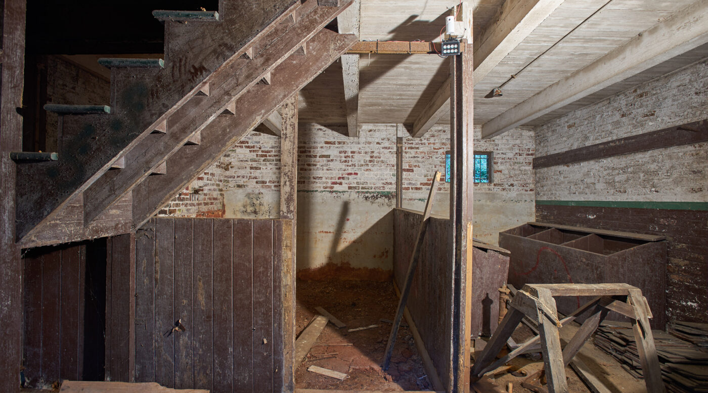 Photo of the interior of the stable in pre-restoration condition.