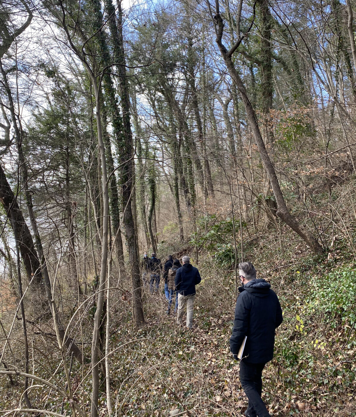 The architecture team follows the trails through the woods behind the Eugenia Williams House.